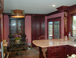 A custom kitchen with square raised cherry panels and custom corbels.