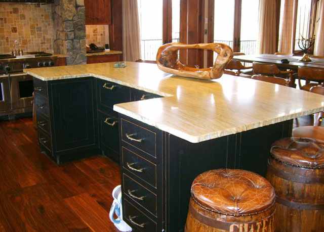 A custom island with a black finish by Christiana Cabinetry.