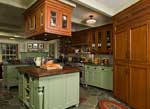 A custom green wood-mode kitchen with cherry upper cabinets.