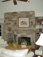 A fireplace mantel with a custom bookshelf next to it.