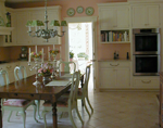 A wood-mode custom kitchen with flat door panels and an heirloom finish.