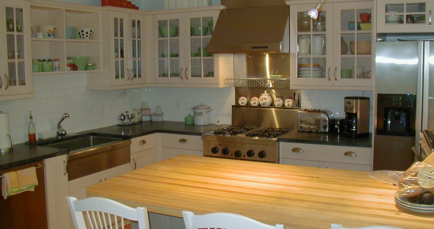 White Wood-Mode kitchen with granite top, and island with wooden top.