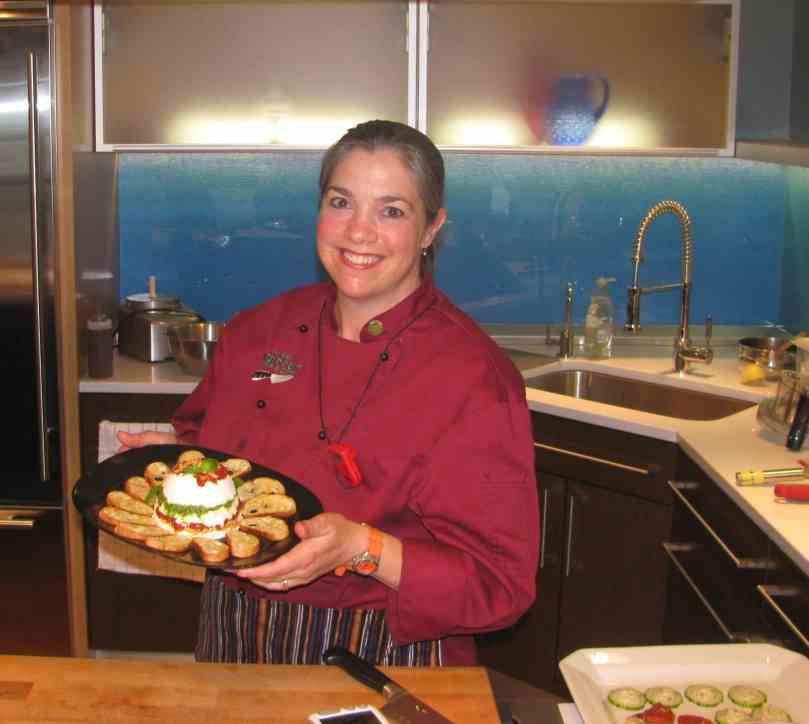 Jessica Bard holding a dish made at one of our cooking classes.