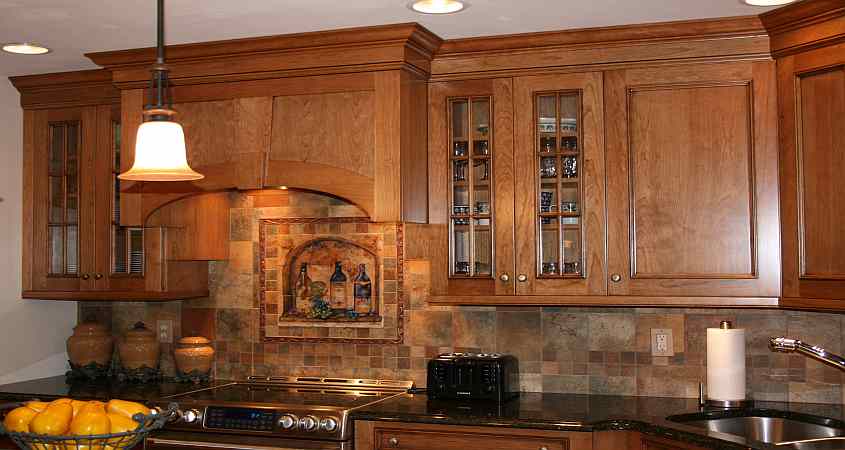 A Brookhaven Cherry Kitchen with a custom backsplash.