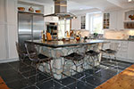 A white brookhaven kitchen with a contemporary range hood.