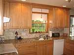 A raised panel maple kitchen with a light stain.