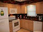 A maple brookhaven kitchen with a brick backsplash.