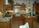 A cherry custom kitchen with an apron sink.