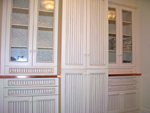 Cabinetry with waincoat panels for storage.