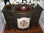 An old fashion green vanity on legs.