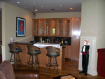 A bar with maple cabinetry around it.