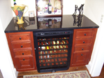 A wine storage unit with cabinetry around it on both sides.